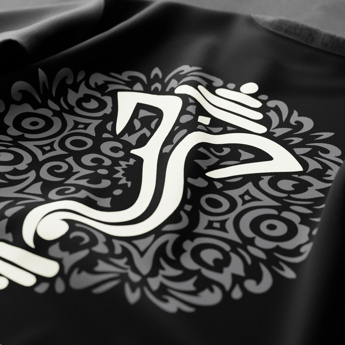 Ganesh black t-shirt featuring intricate designs with a prominent symbol in the center