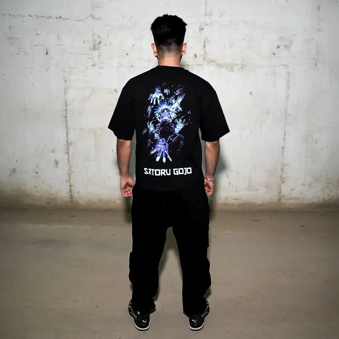 Rear view of model wearing Satoru Gojo black oversize t-shirt with blue anime graphic and bold Satoru Gojo text