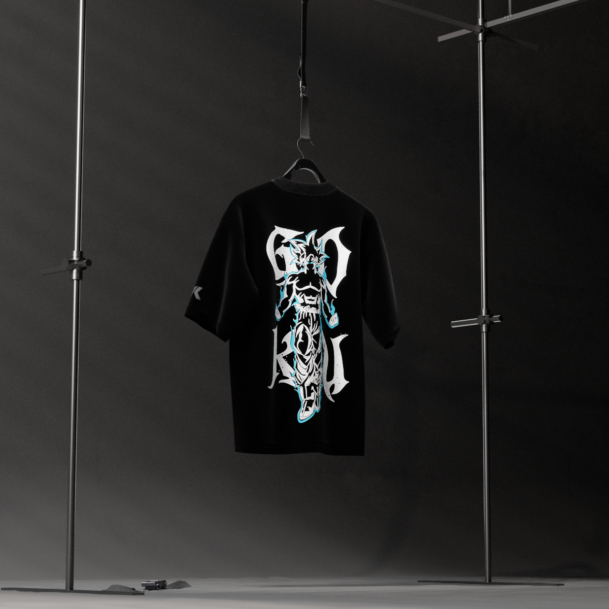 Vlack Son Goku black oversized t-shirt with bold white and cyan anime style back graphic hanging in studio display
