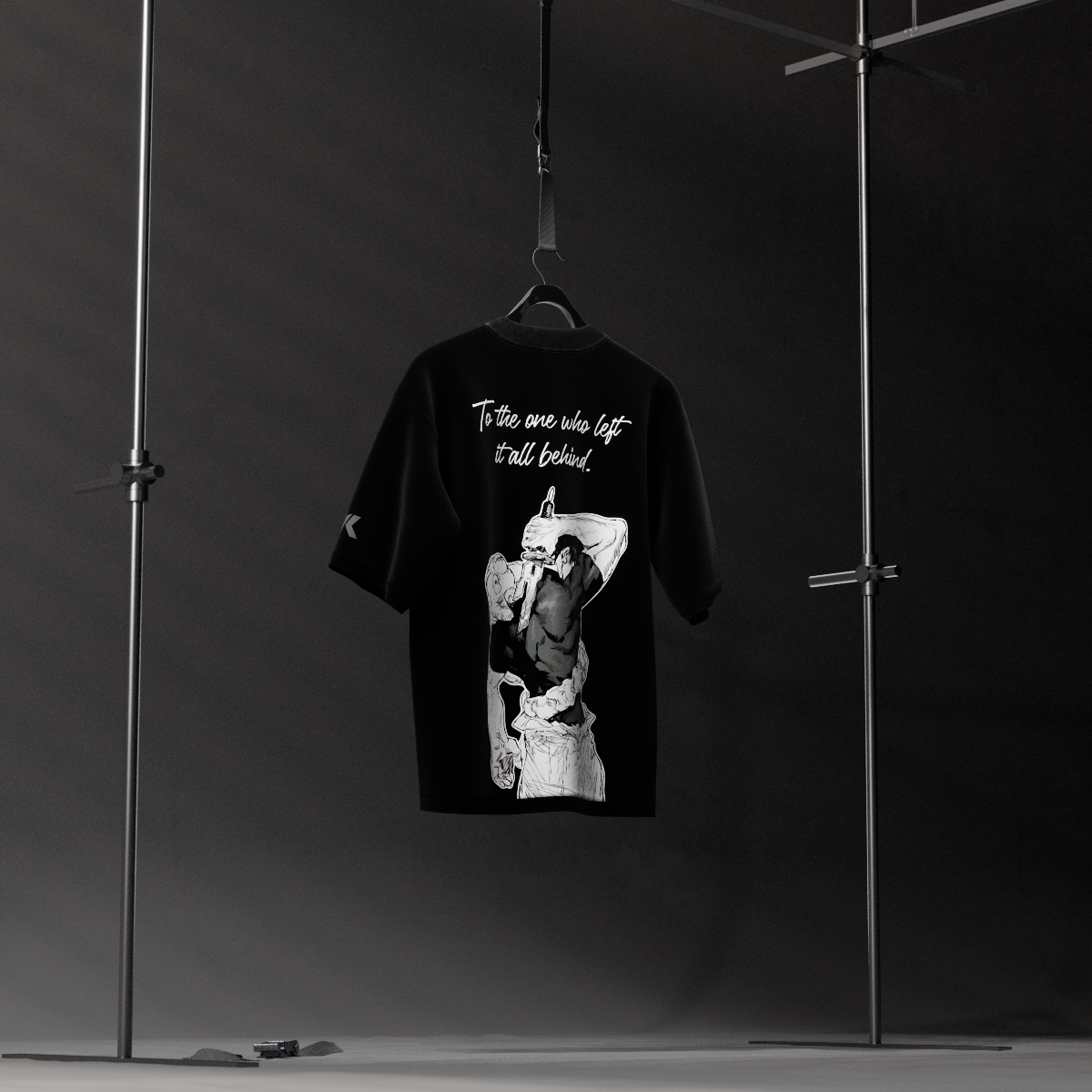 Jujutsu Kaisen Toji black oversized t-shirt hanging on hanger in studio showing white back print and script