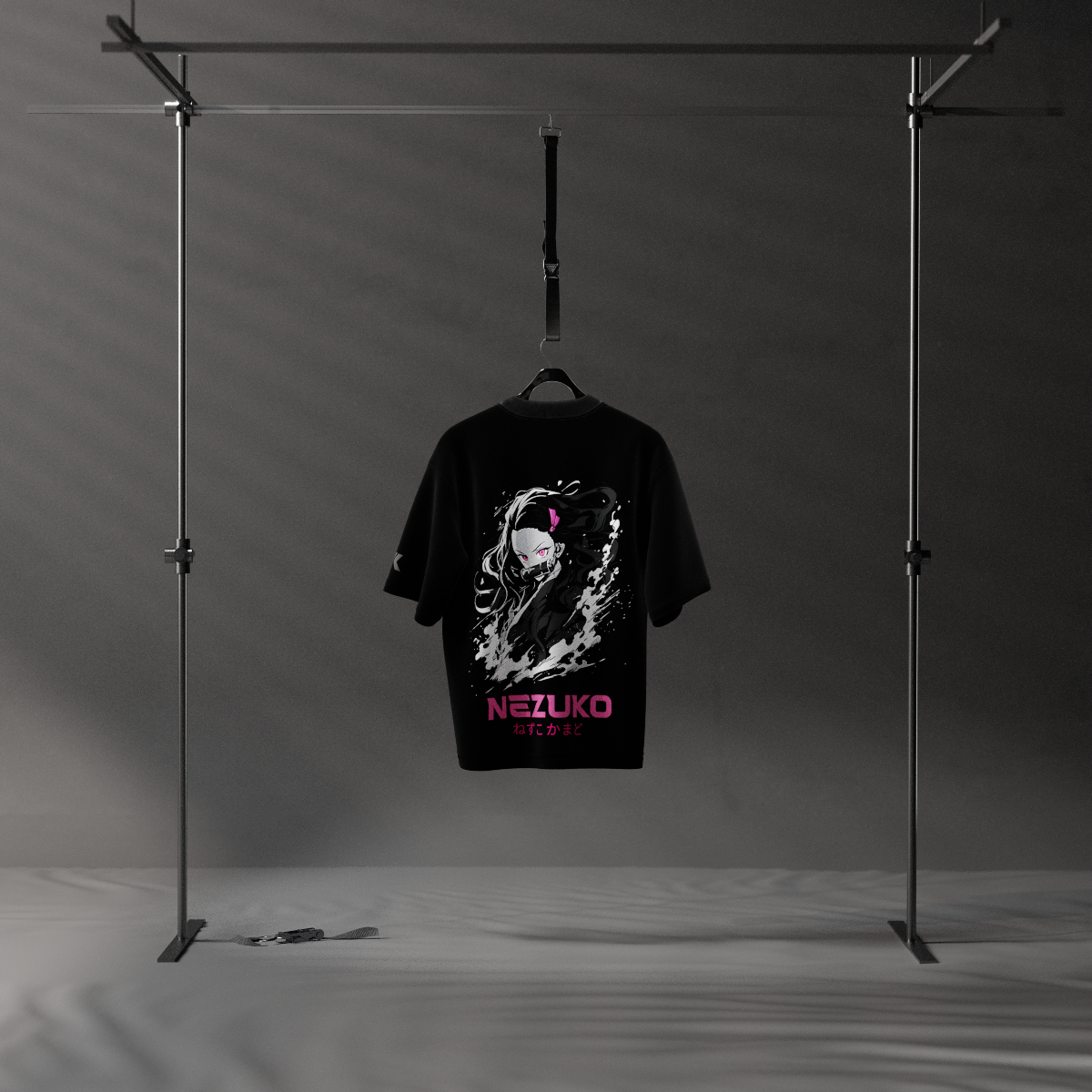 Black Vlack oversized tee with pink Nezuko graphic on back hanging on studio rack Nezuko Kamado oversized t-shirt
