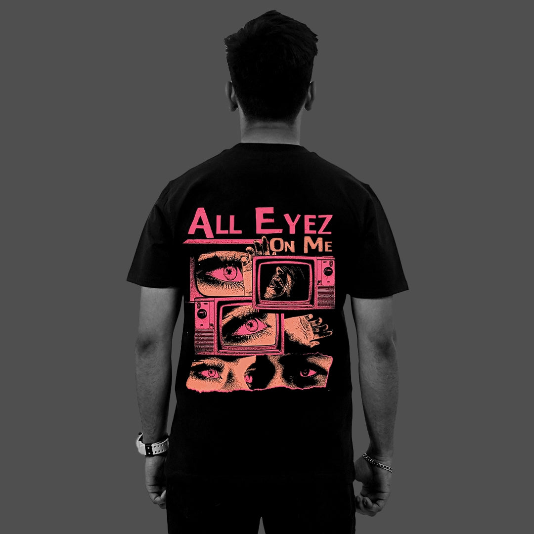 Back view of model wearing Vlack black graphic streetwear t-shirt with pink All Eyez On Me eye collage