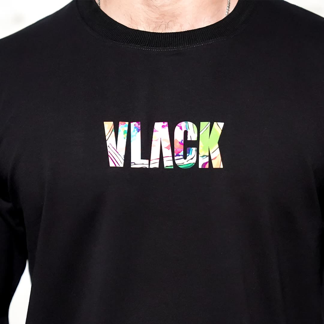 Close up of Vlack black oversized streetwear t-shirt with colorful floral VLACK logo centered on chest