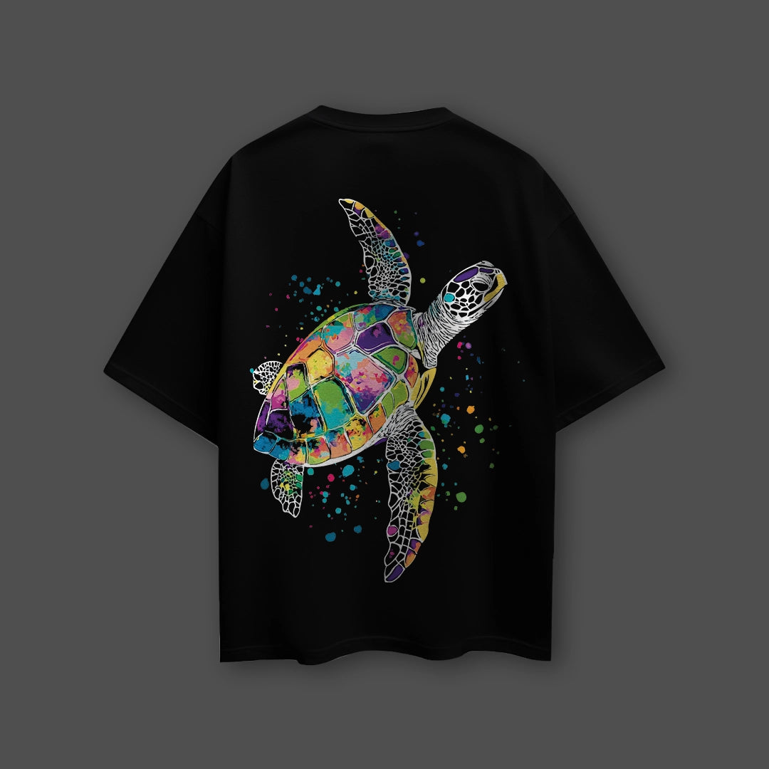 Vlack black oversized streetwear t-shirt with vibrant multicolor mosaic sea turtle graphic and paint splatter on back