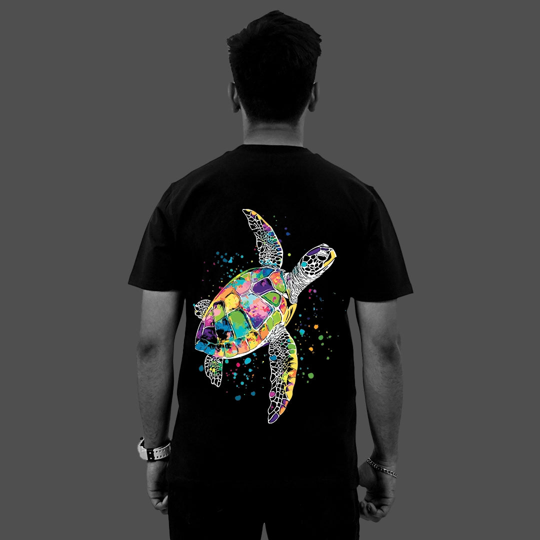 Back view of model wearing Vlack regular fit black streetwear t-shirt with colorful watercolor sea turtle graphic