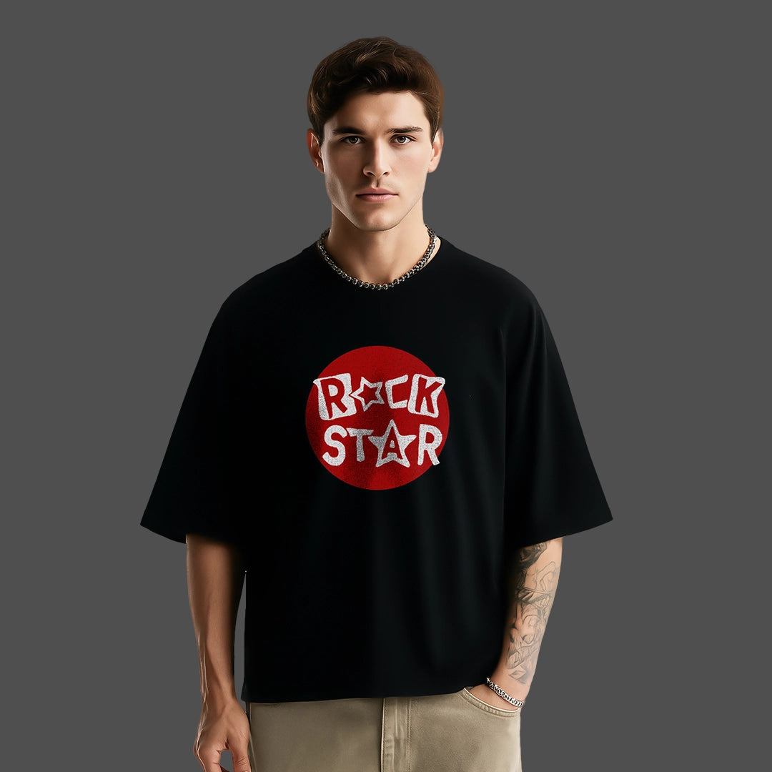 Model wearing a black oversized rockstar t-shirt with red and white graphic design