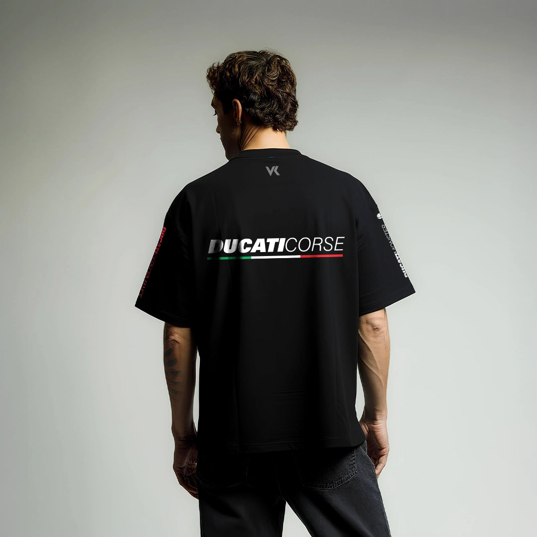 Model wearing a Ducati Corse black oversized t-shirt showcasing a stylish back design