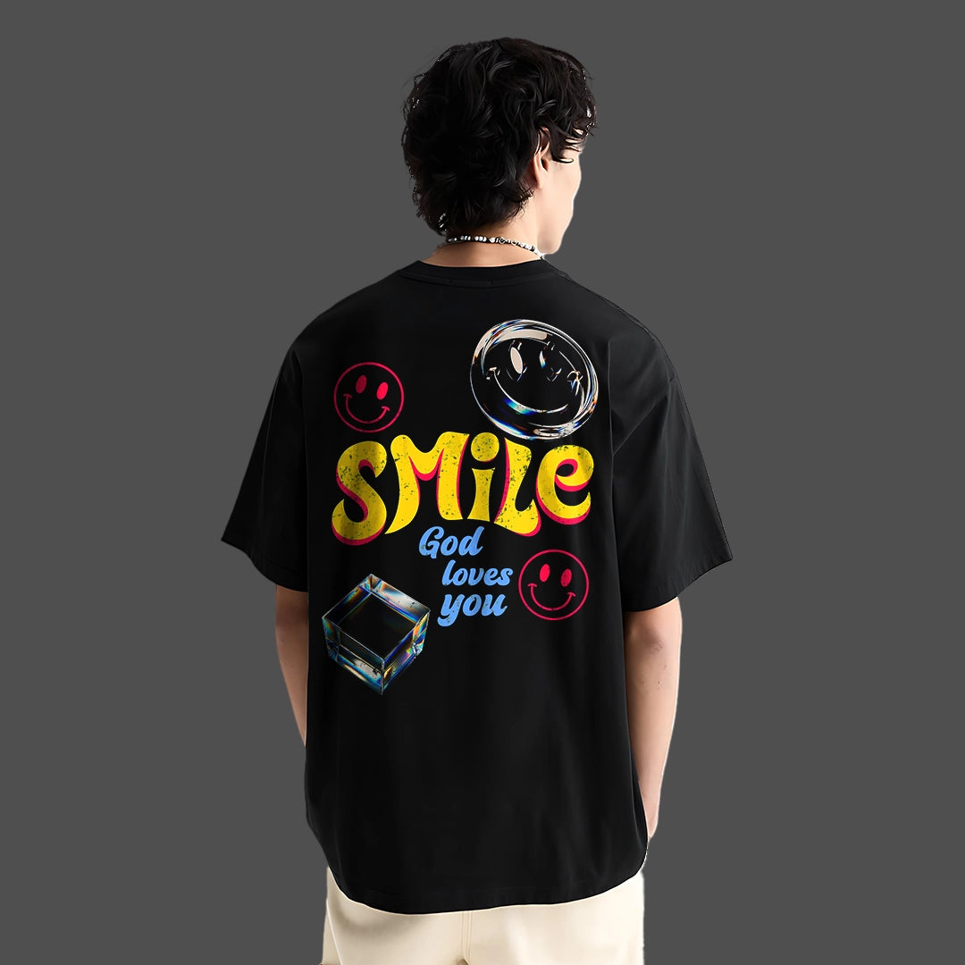 God Loves You oversized black t-shirt featuring colorful graphics and smiley faces on the back