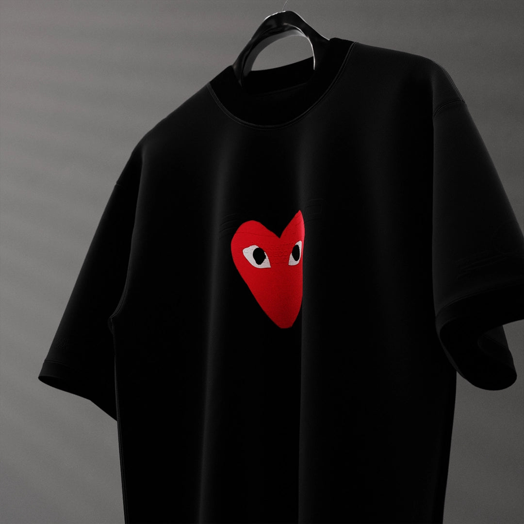 Oversized black heart eyes t-shirt featuring a bold red heart graphic for a trendy look