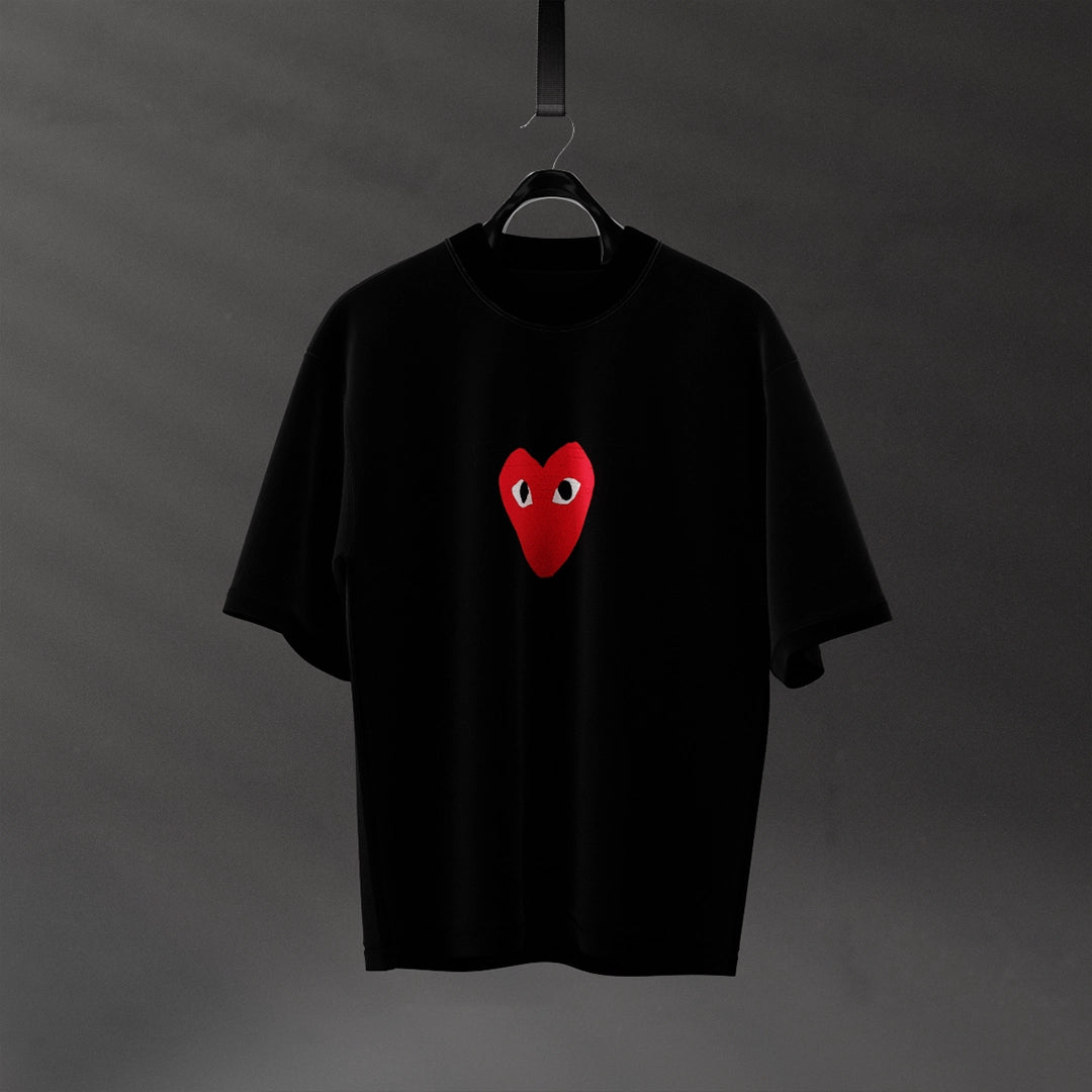 Oversized black heart eyes t-shirt featuring a red heart with eyes on the front.