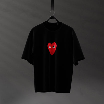 Oversized black heart eyes t-shirt featuring a red heart with eyes on the front.