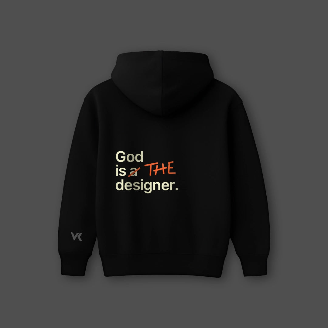 Oversized black hoodie featuring the phrase God is THE designer in stylish typography
