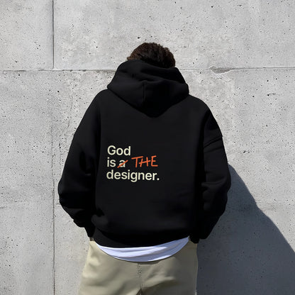Oversized black hoodie by Vlack with bold text 'God is the designer' in colorful lettering