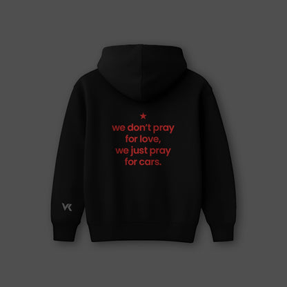Oversized black hoodie streetwear with red text that reads we don't pray for love, we just pray for cars