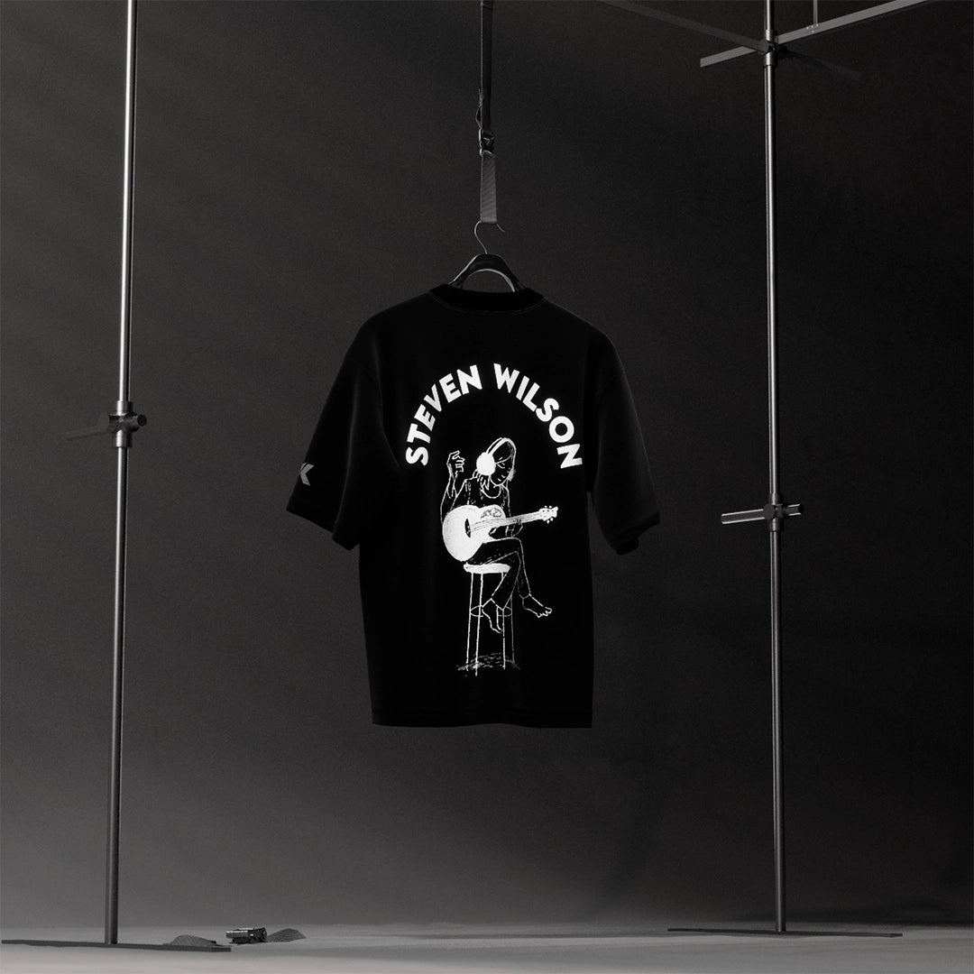 Steven Wilson oversized black t-shirt featuring a musician playing guitar on a stool