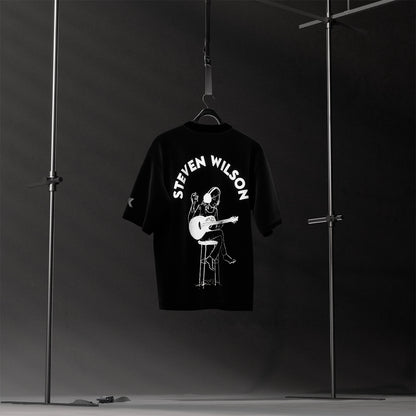 Steven Wilson oversized black t-shirt featuring a musician playing guitar on a stool