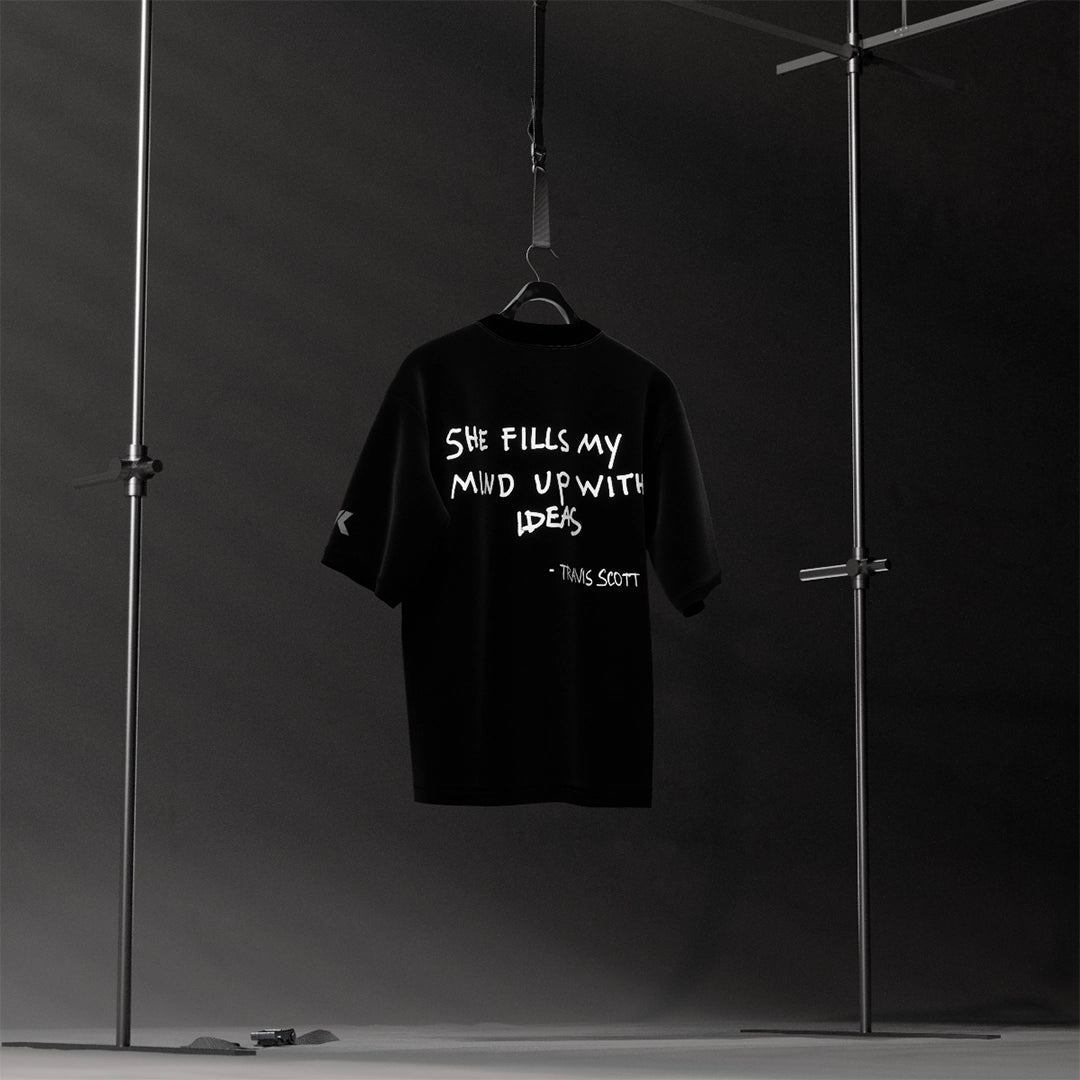 Travis Scott black oversized t-shirt featuring bold graphic text on the back