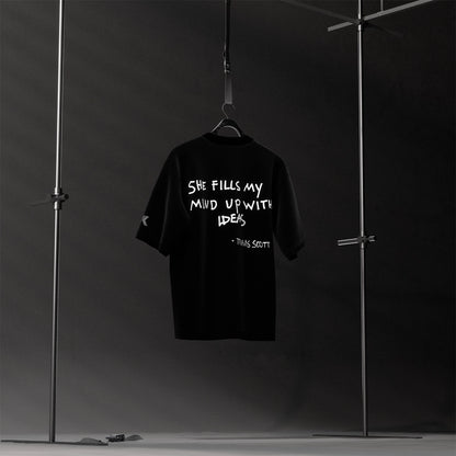 Travis Scott black oversized t-shirt featuring bold graphic text on the back