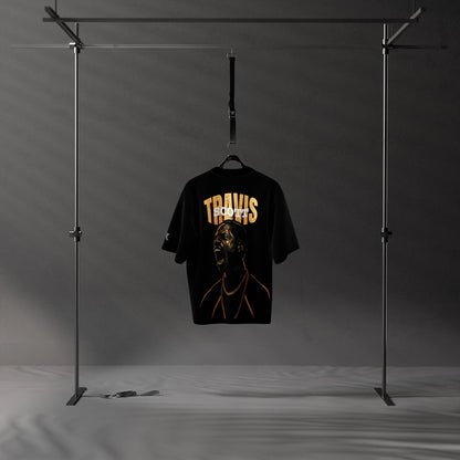 Travis Scott scream oversized black t-shirt displayed on a hanger in a modern setting