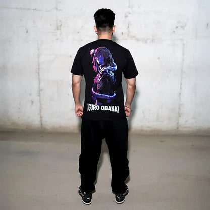 Rear view of model wearing Iguro Obanai black oversized t-shirt with neon anime graphic and bold logo