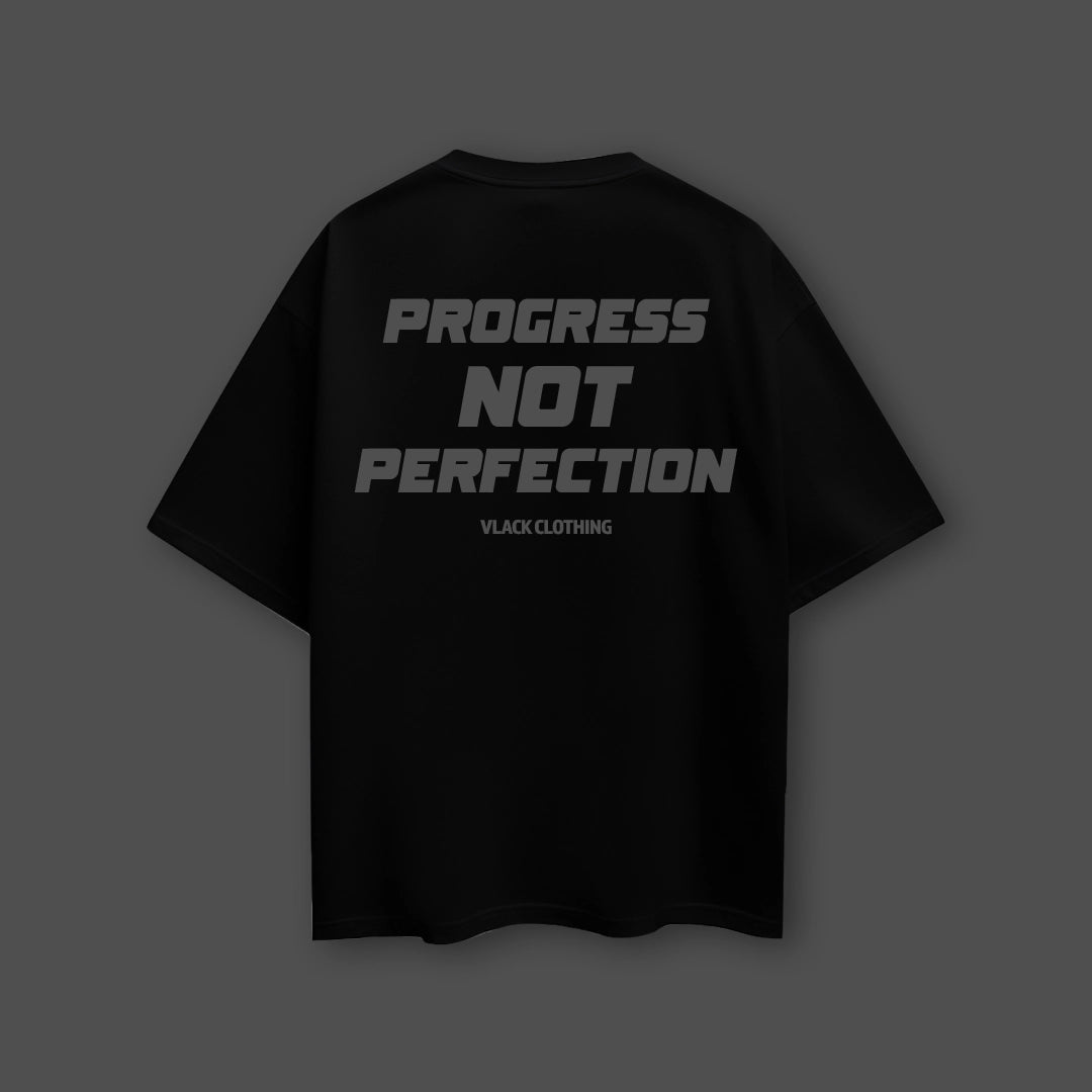 Back view of a Vlack black oversized streetwear t-shirt featuring the text Progress Not Perfection