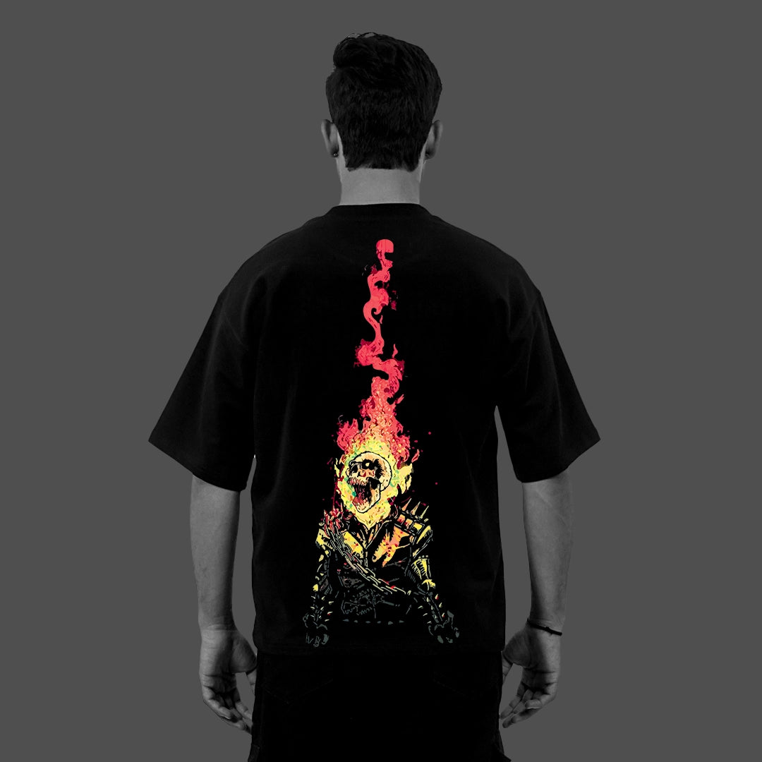 Back view male model wearing Vlack black oversized streetwear t-shirt with large red yellow flaming skull graphic