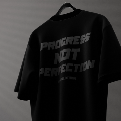 Black oversized streetwear t-shirt with 'Progress Not Perfection' graphic design