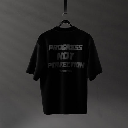 Black oversized streetwear t-shirt with 'Progress Not Perfection' slogan on the back