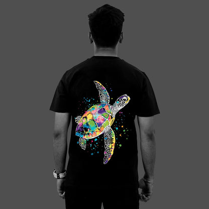 Back view of model wearing Vlack regular fit black streetwear t-shirt with colorful watercolor sea turtle graphic